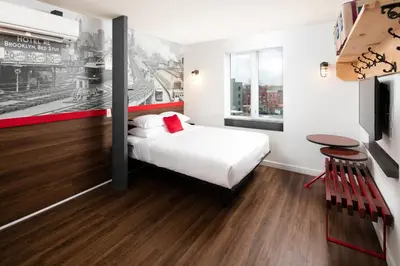 a hotel room with a bed and a table at Hotel 1080 in Brooklyn