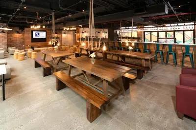 a dining room with wooden tables and chairs at Hotel 1080 in Brooklyn
