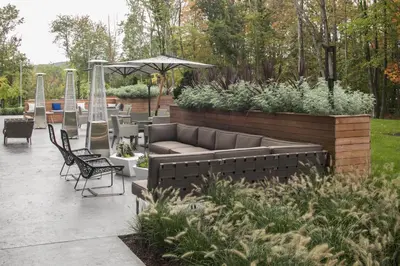 a patio with a couch and chairs and an umbrella at Hotel Zero Degrees Danbury in Danbury