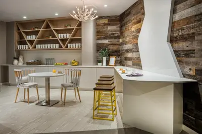 a kitchen with a counter and a table and chairs at Hotel Zero Degrees Danbury in Danbury