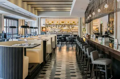 a restaurant with tables and chairs and a bar at Hotel Zero Degrees Danbury in Danbury