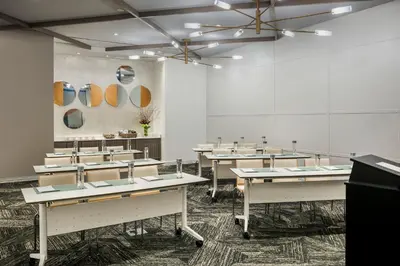 a room with tables and mirrors on the wall at Hotel Zero Degrees Danbury in Danbury