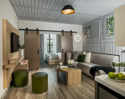 a living room with a couch and a table at Hotel Zero Degrees Danbury in Danbury