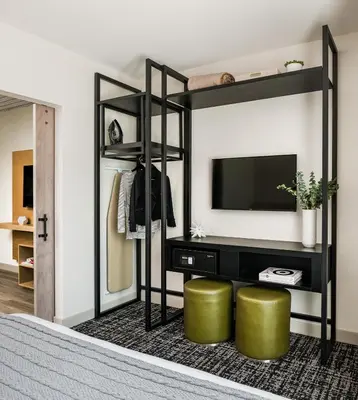 a bedroom with a black bunk bed with a television at Hotel Zero Degrees Danbury in Danbury