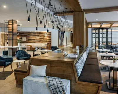a restaurant with tables and chairs and a lobby at Hotel Zero Degrees Danbury in Danbury