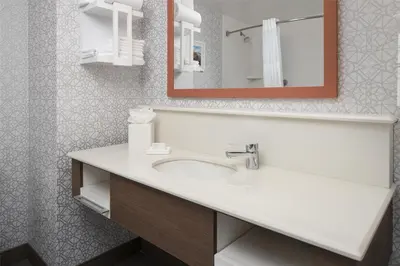 a bathroom with a sink and a mirror at Hampton Inn & Suites Yonkers - Westchester in Yonkers