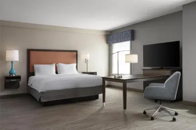 a bedroom with a bed and a desk and a television at Hampton Inn & Suites Yonkers - Westchester in Yonkers