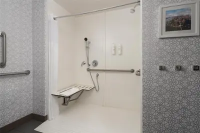 a shower with a glass door in a bathroom at Hampton Inn & Suites Yonkers - Westchester in Yonkers