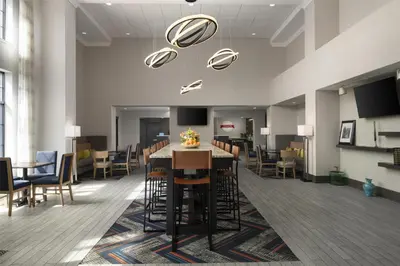 a dining room with a table and chairs at Hampton Inn & Suites Yonkers - Westchester in Yonkers