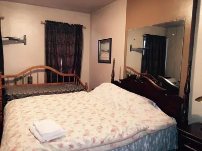 a bedroom with a bed and a large mirror at Beauty Near Times Square in New York