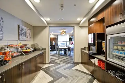 a kitchen with a counter and a dining room at TownePlace Suites by Marriott Dover Rockaway in Dover