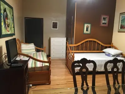 a bedroom with a bed and a desk with a computer at Times Square Perfect Home in New York