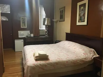a bedroom with a bed with two towels on it at Times Square Perfect Home in New York