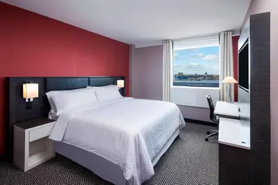 a bedroom with a large white bed and a window at Four Points by Sheraton Manhattan Midtown West in New York