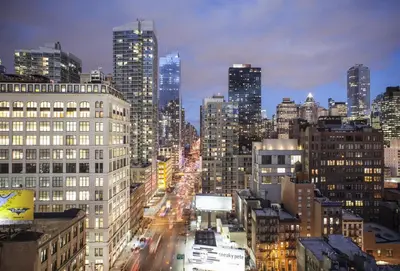 a view of a city at night with buildings at Four Points by Sheraton Manhattan Midtown West in New York
