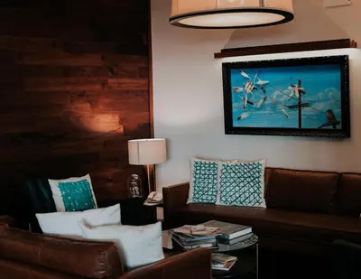 a living room with a couch and a table at Feather Factory Hotel in Queens
