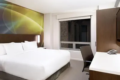 a hotel room with two beds and a window at LUMA Hotel - Times Square in New York