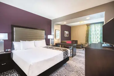 a hotel room with a bed and a desk at La Quinta Inn & Suites by Wyndham Clifton Park Saratoga Area 1749 Route 9 in Clifton Park