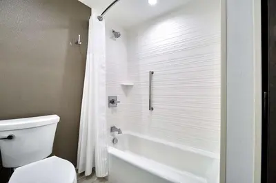 a bathroom with a tub and a toilet and a shower at Hilton Garden Inn Roslyn in Roslyn