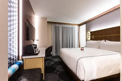 a hotel room with a large bed and a television at Crowne Plaza HY36 Midtown Manhattan by IHG in New York