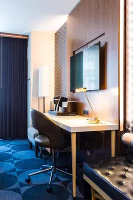 a hotel room with a desk and a chair at Crowne Plaza HY36 Midtown Manhattan by IHG in New York