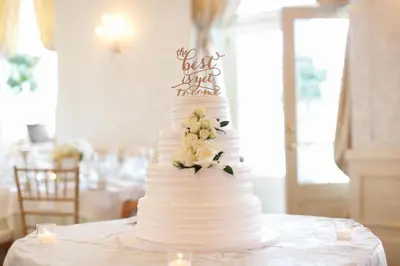a white wedding cake sitting on top of a table at The Hotel Northampton in Northampton