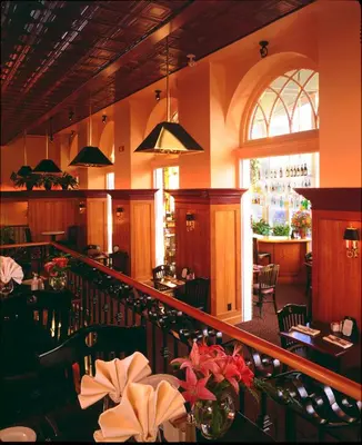 a restaurant with a staircase and a dining room at The Hotel Northampton in Northampton