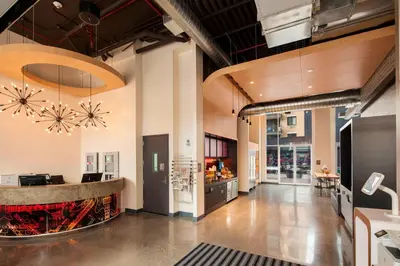 a lobby of a building with a bar in it at Aloft Long Island City-Manhattan View in Queens