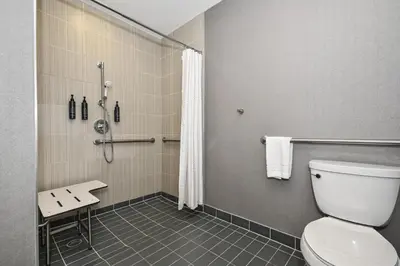 a bathroom with a toilet and a shower at Aloft Long Island City-Manhattan View in Queens