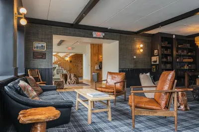 a living room with couches and chairs at Hunter Lodge, a Bluebird by Lark in Hunter