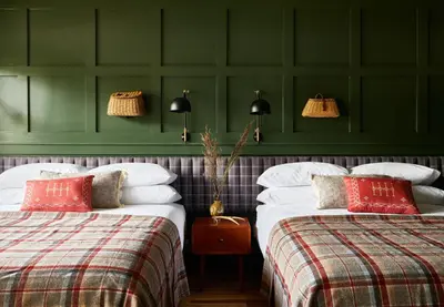 two beds in a room with green walls at Hunter Lodge, a Bluebird by Lark in Hunter