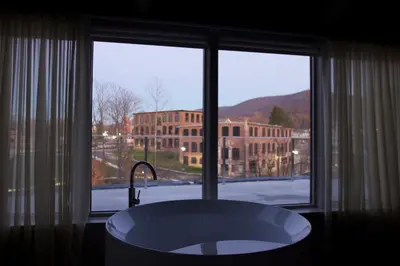 a bathroom with a bath tub in front of a window at The Roundhouse in Beacon