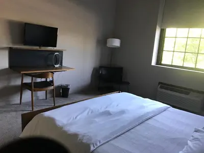 a bedroom with a bed and a flat screen tv at The Roundhouse in Beacon