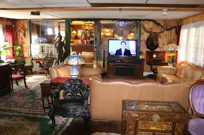 a living room with couches and a flat screen tv at Colonial Inn in Pine Hill