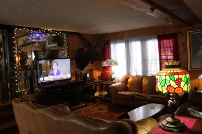 a living room with a couch and a television at Colonial Inn in Pine Hill