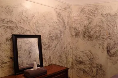 a mirror sitting on a table next to a wall at Carlton Arms Hotel in New York