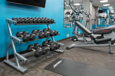 a gym with two tread machines in a room at Fairfield Inn & Suites by Marriott New York Queens/Fresh Meadows in Queens