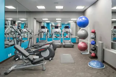 a gym with several treadmills and exercise equipment at Fairfield Inn & Suites by Marriott New York Queens/Fresh Meadows in Queens