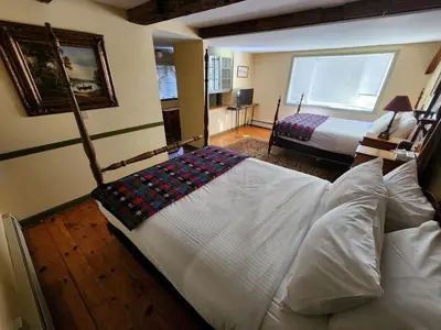 a bedroom with two beds and a window at Arlington Inn & Spa in Arlington