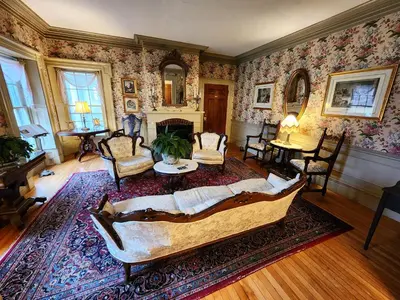 a living room with a couch and a table at Arlington Inn & Spa in Arlington