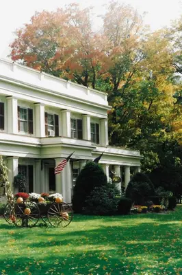 a white house with a flower cart in front of it at Arlington Inn & Spa in Arlington