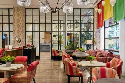 a restaurant with tables and chairs and windows at The Whitby Hotel in New York