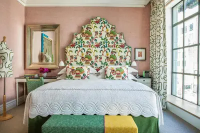 a bedroom with a large bed with a large headboard at The Whitby Hotel in New York