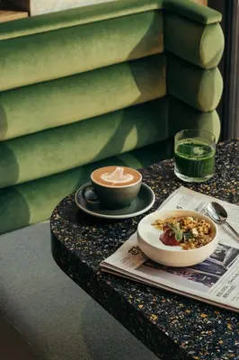 a table with a bowl of food and a drink at Park Terrace Hotel in New York