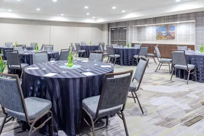 a conference room with tables and chairs and a podium at Courtyard by Marriott Yonkers Westchester County in Yonkers