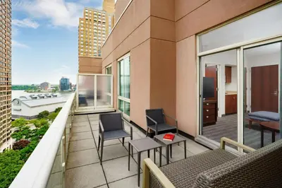 a balcony with chairs and tables on a building at Courtyard by Marriott New York Manhattan Upper East Side in New York