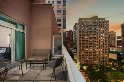 a balcony with chairs and a table on a building at Courtyard by Marriott New York Manhattan Upper East Side in New York