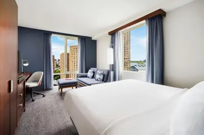 a hotel room with a bed and a desk and window at Courtyard by Marriott New York Manhattan Upper East Side in New York