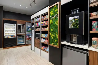 a grocery store aisle with a refrigerator and a tv at Courtyard by Marriott New York Manhattan Upper East Side in New York