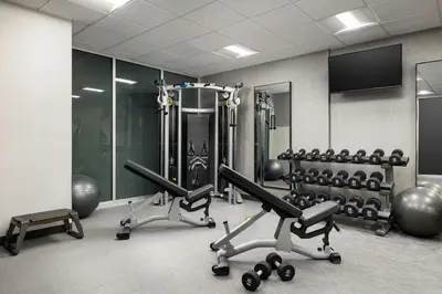 a gym with two treadmills and exercise machines at Courtyard by Marriott New York Manhattan Upper East Side in New York